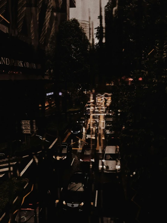 a street filled with lots of traffic next to tall buildings, inspired by Thomas Struth, unsplash contest winner, it's dark, gif, trending on vsco, devastated