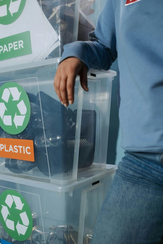 a person standing next to a pile of trash, packaging, green, thumbnail, translucent