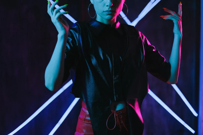 a woman standing in front of a neon light, trending on pexels, neo-figurative, leather clothing, androgynous vampire, nightclub dancing inspired, fashion studio lighting