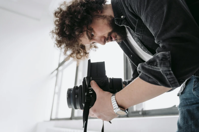 a man taking a picture with a camera, a picture, pexels contest winner, art photography, looking down on the camera, profile posing, indoor picture, in an action pose