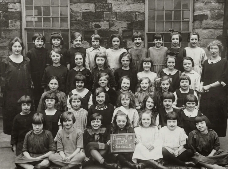 a black and white photo of a group of children, by Helen Stevenson, blackboard in background, school girl in gothic dress, vintage glass plate photograph, greig fraser
