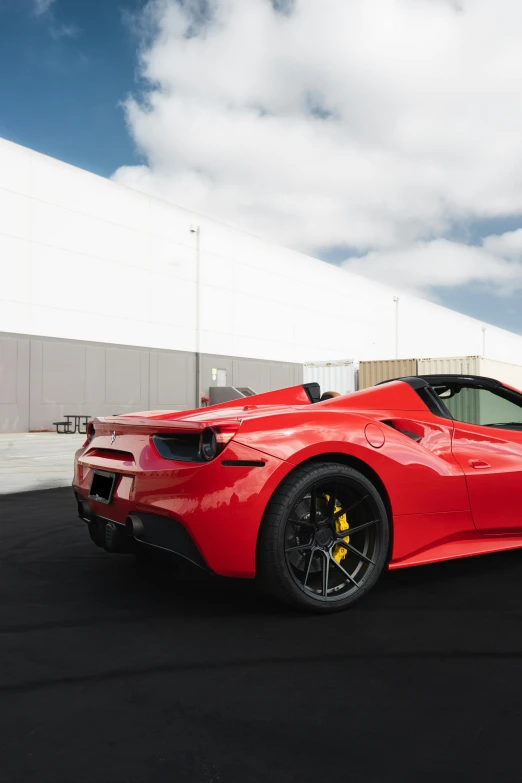 a red sports car parked in a parking lot, promo photo, square, f / 3, f12