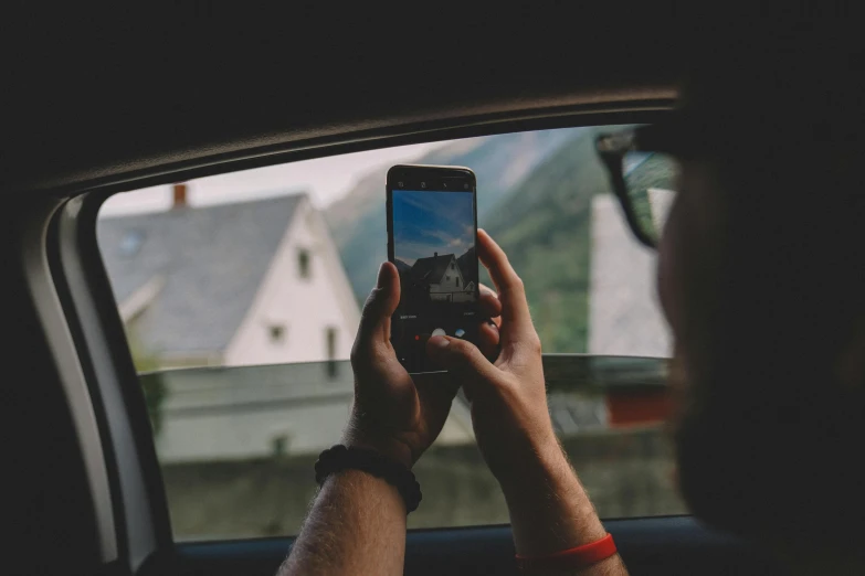 a man taking a picture of a house through a car window, pexels contest winner, hq 4k phone wallpaper, avatar image, 24mp, instagram photo