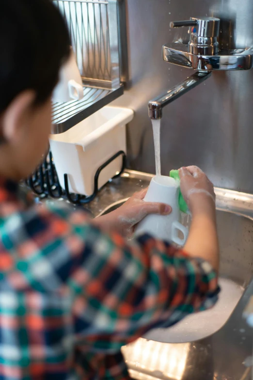 a woman washing dishes in a kitchen sink, by Yasushi Sugiyama, pexels, holding a boba milky oolong tea, square, commercial washroom hand dryer, children's
