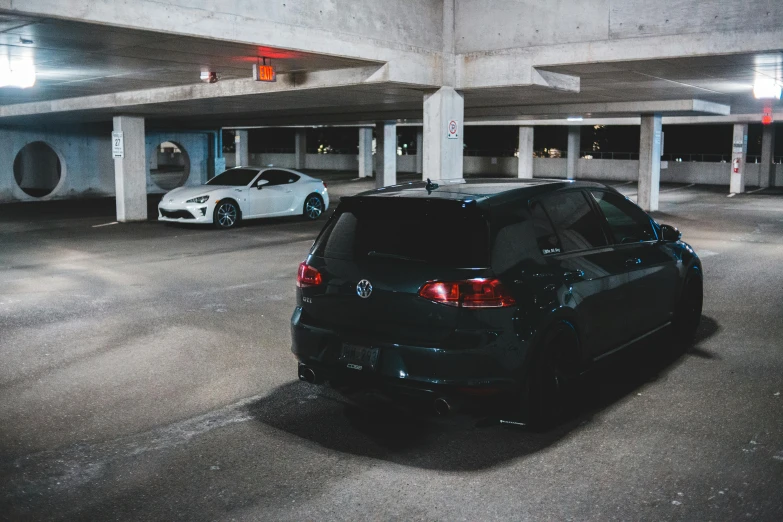 a couple of cars parked in a parking garage, a picture, by Adam Rex, unsplash, wrx golf, vantablack gi, pr shoot, tunnels