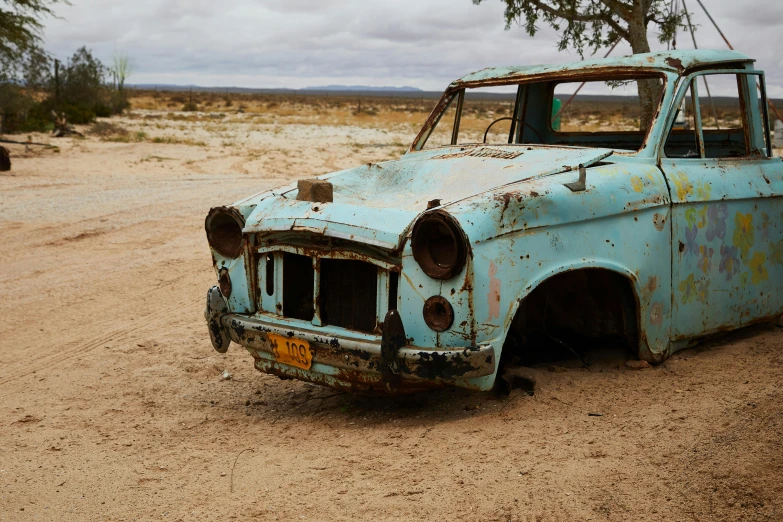 an old car sitting in the middle of a dirt road, by Lee Loughridge, unsplash, auto-destructive art, square, turquoise, african sybil, hd footage