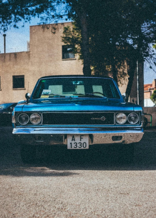 a blue car parked on the side of the road, an album cover, by Elsa Bleda, pexels contest winner, hypermodernism, muscle cars, square, an ancient, low iso