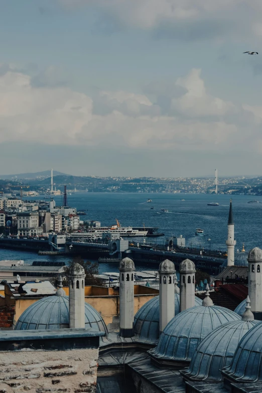 a view of a city from the top of a building, inspired by Niyazi Selimoglu, pexels contest winner, hurufiyya, harbour in background, domes, slide show, hills and ocean