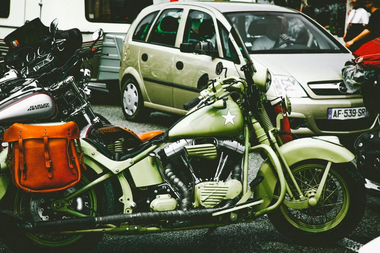 a couple of motorcycles parked next to each other, a colorized photo, pexels contest winner, olive green, harley davidson motorbike, lo fi, 🚿🗝📝