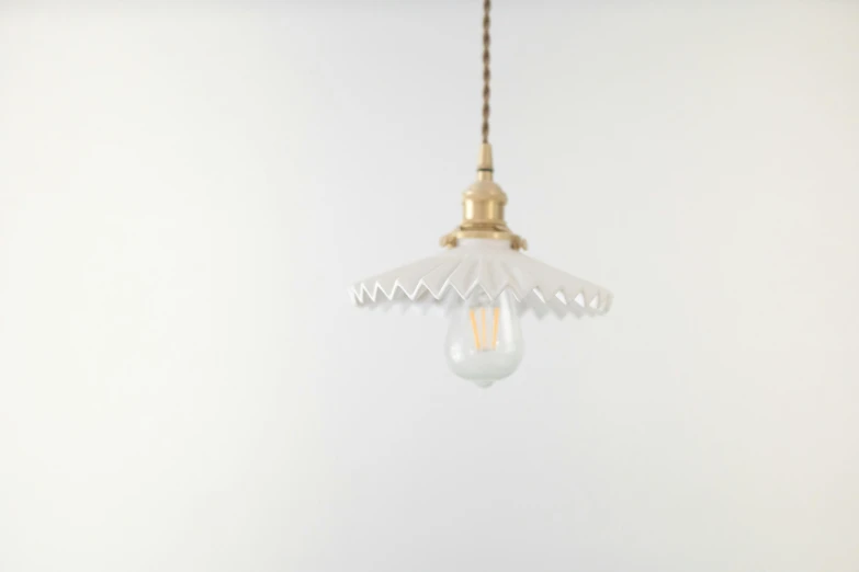 a close up of a light hanging from a ceiling, inspired by Aimé Barraud, cream white background, modeled, frill, enamel