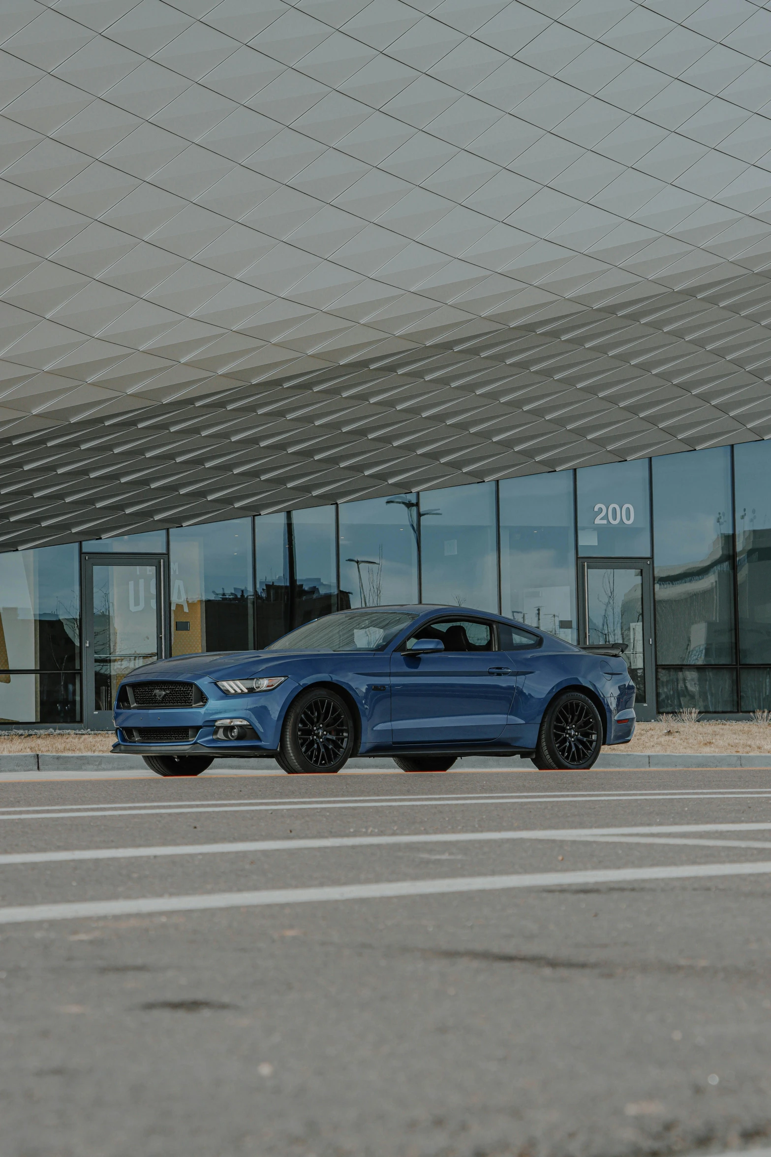 a blue ford mustang parked in front of a building, by Jan Tengnagel, official store photo, square, panorama, shot on sony a 7