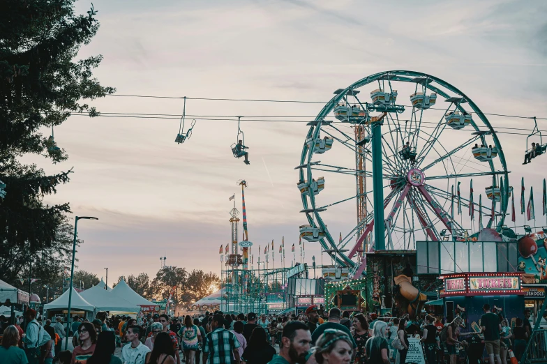 a carnival filled with lots of people and a ferris wheel, a photo, pexels contest winner, caulfield, profile image, early morning mood, some stalls