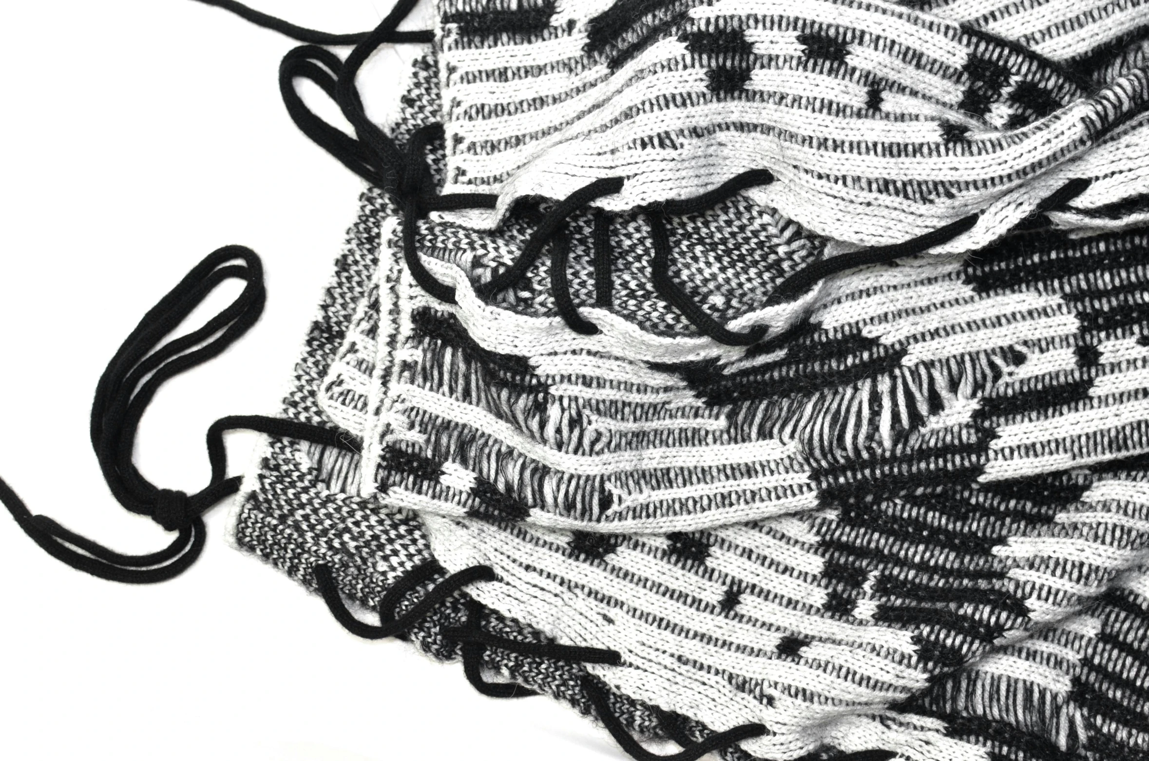 a close up of a black and white scarf, by Daniel Lieske, detailed string text, mesh fabrics, masks, dezeen