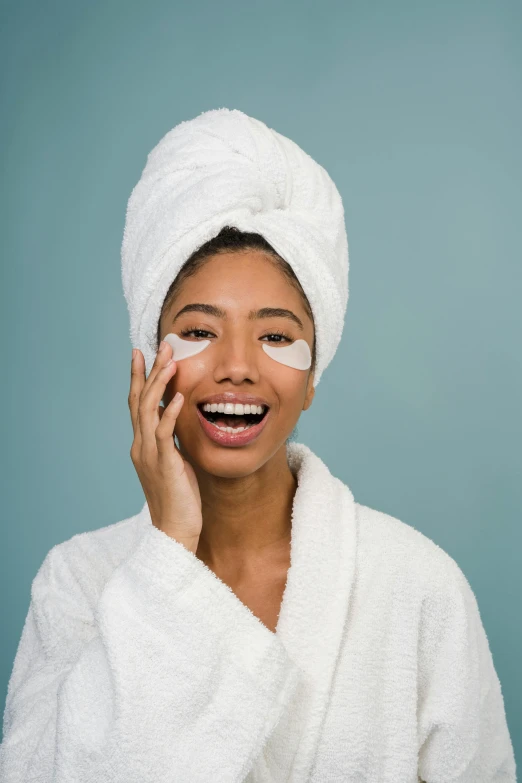 a woman with a towel on her head talking on a cell phone, by Carey Morris, trending on pexels, eye patch over left eye, photoshoot for skincare brand, happily smiling at the camera, oriental face