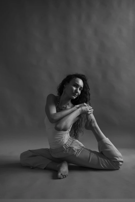 a black and white photo of a woman sitting on the floor, by Elizabeth Polunin, yoga, high quality image, artem chebokha, vivid)