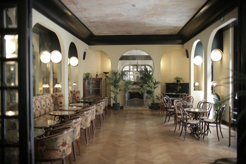 a dining room filled with lots of tables and chairs, inspired by Emilio Grau Sala, unsplash, art nouveau, studio ghibili, the flamingo cafe, video, quiet and serene atmosphere