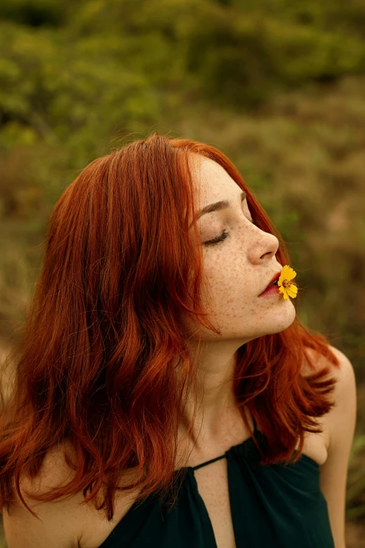 a woman with a flower in her mouth, an album cover, pexels, ( redhead, thoughtful, beautiful yellow woman, college