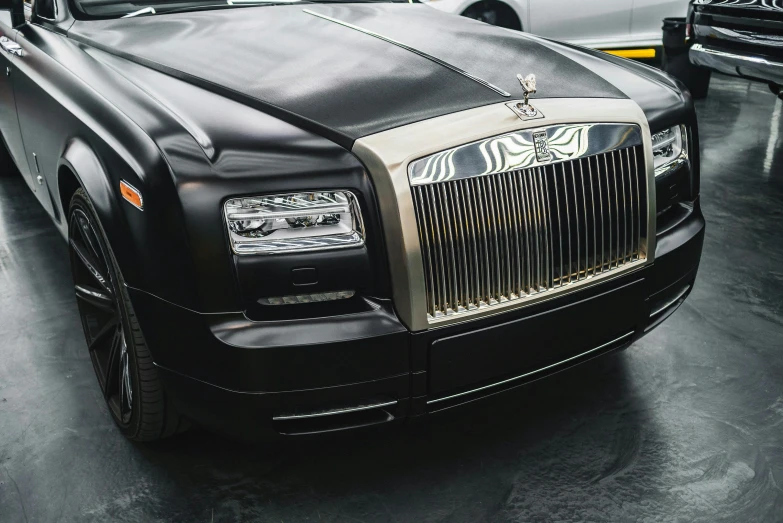 a black rolls royce parked in a garage, an album cover, by Daniel Gelon, unsplash, renaissance, square, extremely polished, in 2 0 1 2, a close up shot