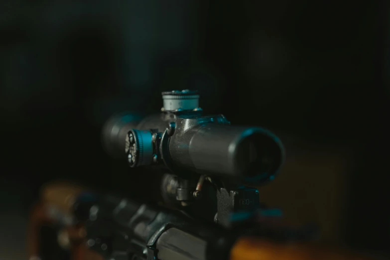 a close up of a rifle on a table, by Adam Marczyński, pexels contest winner, night vision goggles, background image, blurry, high quality photo