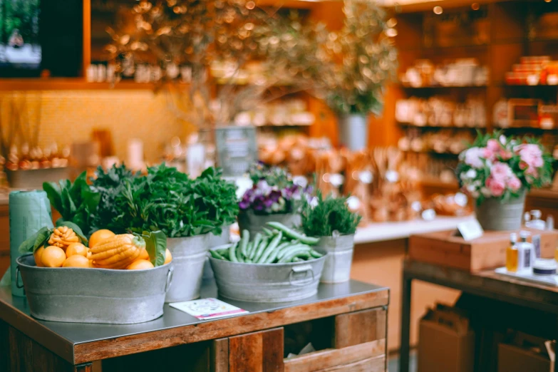 a wooden table topped with buckets filled with fruit and vegetables, by Carey Morris, pexels, flower shop scene, soft glow, rows of lush crops, looking in front