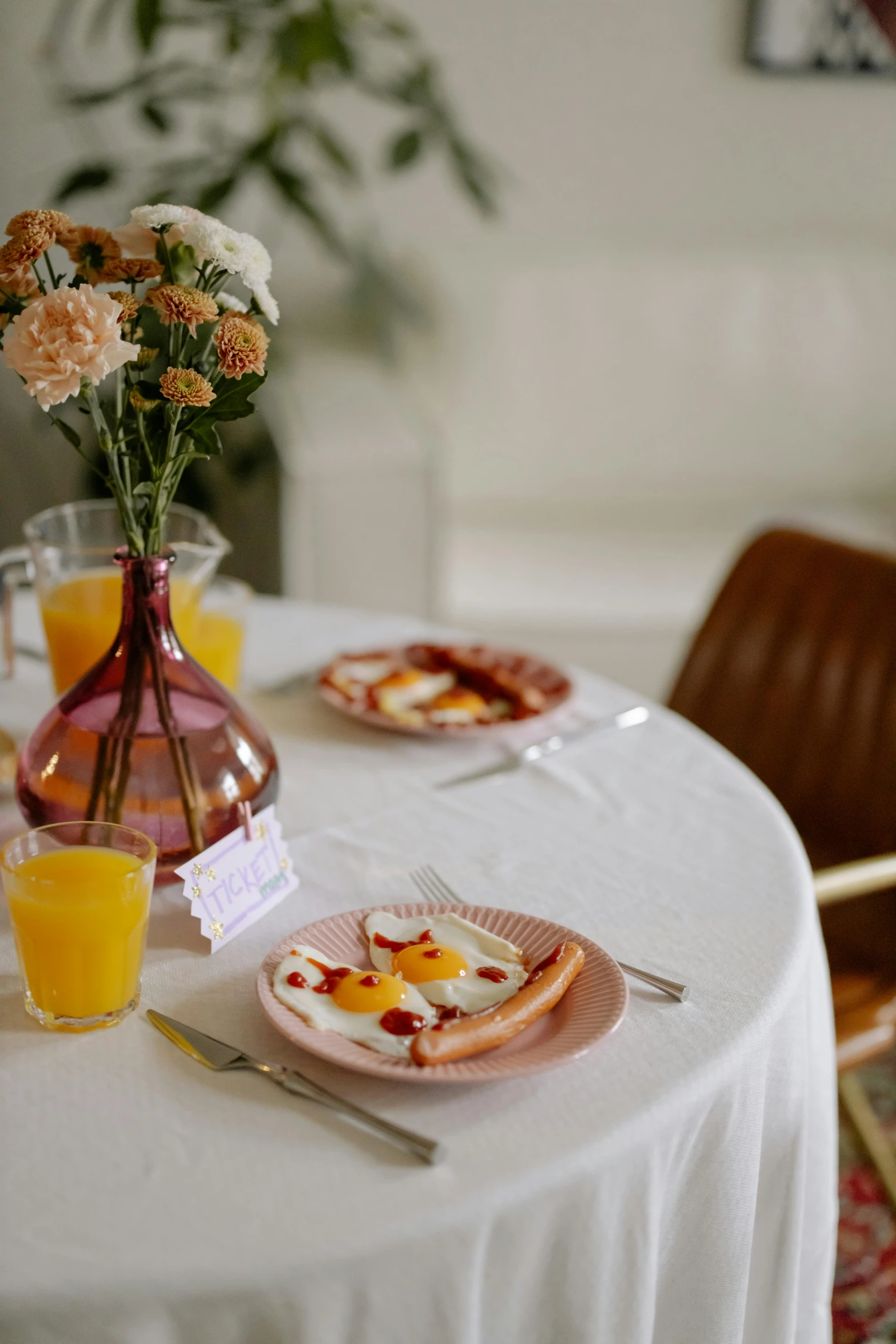 a table topped with plates of food next to a vase of flowers, morning time, eggs, pink and orange, branding