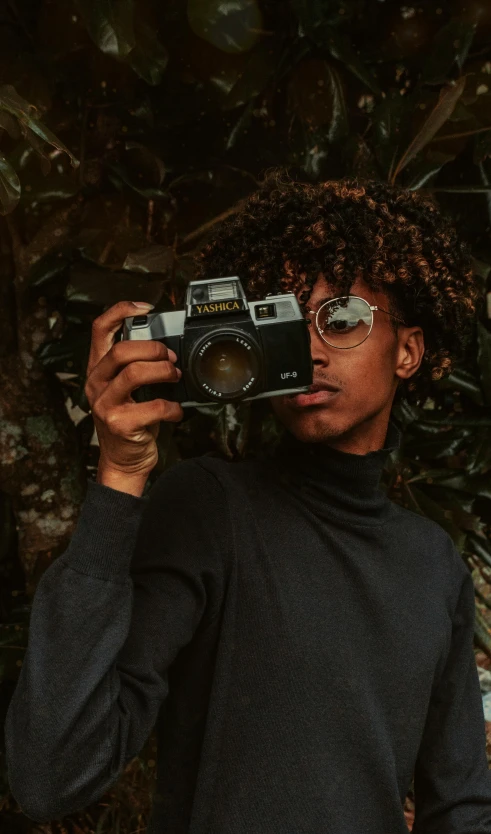 a man taking a picture of himself with a camera, a picture, by Maxwell Bates, pexels contest winner, visual art, a teen black cyborg, man with glasses, with brown skin, top down photo