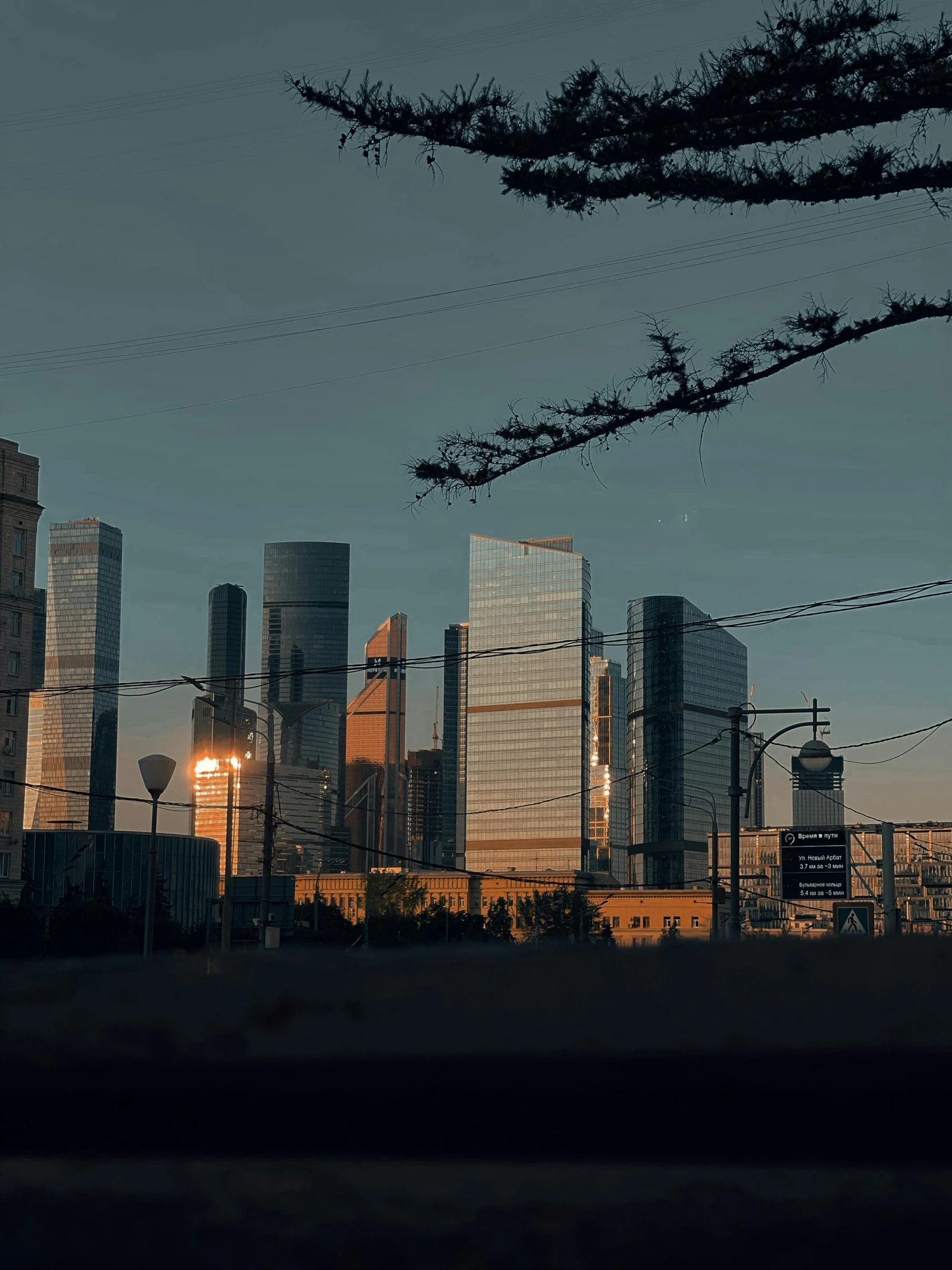 a view of a city from a distance at dusk, an album cover, pexels contest winner, socialist realism, skyscrapers, russian architecture, taken on a 2000s camera, late afternoon light