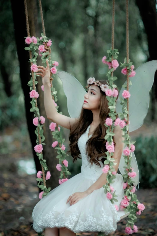 a woman in a white dress sitting on a swing, by Marie Angel, pexels contest winner, elf girl wearing an flower suit, ulzzang, avatar image, pink