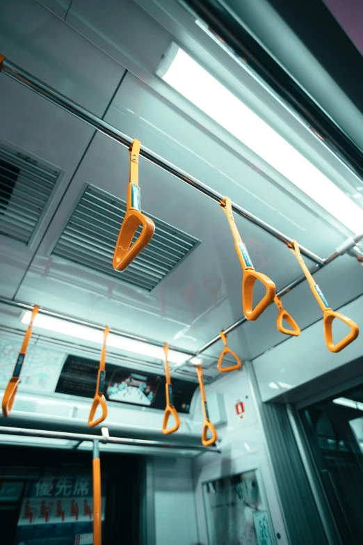 a bunch of scissors hanging from the ceiling of a train, orange line, motion capture system, in a row, showers