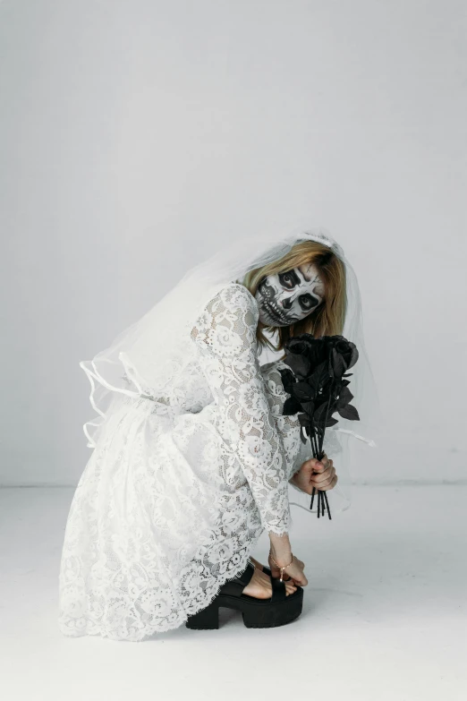 a woman in a wedding dress holding a bouquet, pexels contest winner, gothic art, white facepaint, white backdrop, horror vacui, gif