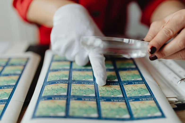 a close up of a person using a cell phone, a microscopic photo, by Julia Pishtar, trending on pexels, arts and crafts movement, nautical maps, on a poststamp, detective, tabletop