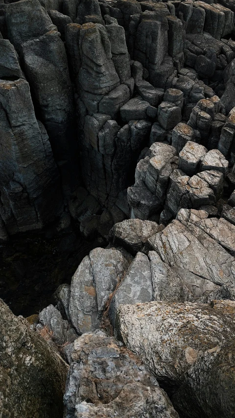 a group of large rocks sitting next to each other, an album cover, pexels contest winner, australian tonalism, huge chasm, high angle vertical, instagram photo, megalitic