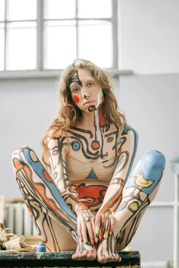 a woman sitting on top of a wooden box, by Jakob Gauermann, trending on pexels, renaissance, facepaint, fullbodysuit, picasso style, covered in circuitry