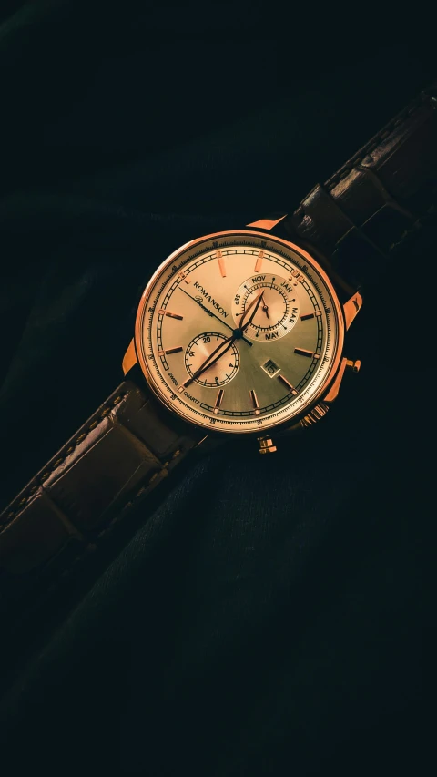 a close up of a watch on a black cloth, an album cover, unsplash, rose gold, archimedes, thumbnail, brown