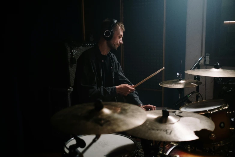 a man that is sitting in front of a drum, studio recording, liam brazier, **cinematic, rectangle