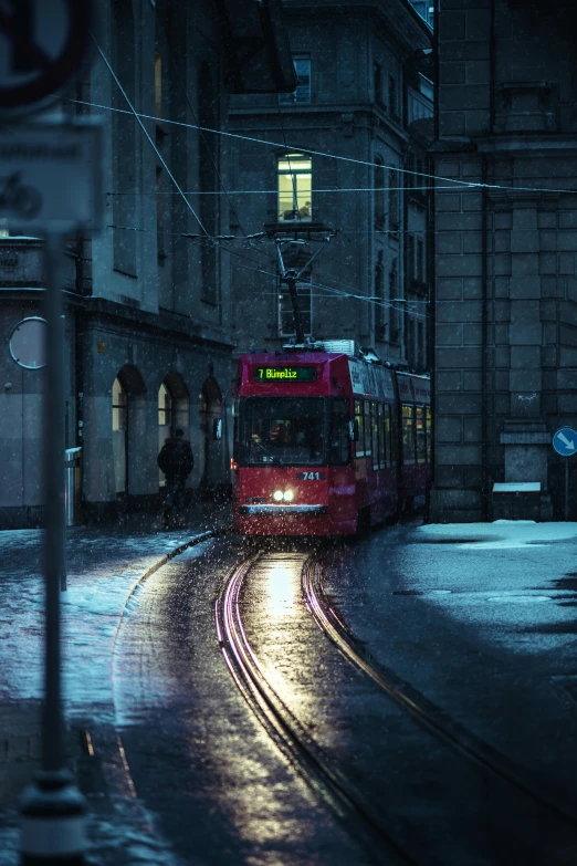 a red train traveling down a street next to tall buildings, pexels contest winner, hyperrealism, moonlight snowing, public bus, bath, hannover