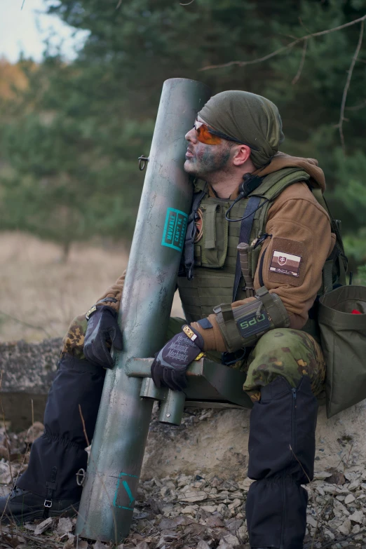 a man sitting on top of a pile of dirt, inspired by Carl Gustaf Pilo, reddit, wearing tactical gear, maus in forest, holding a tower shield, wearing space techwear