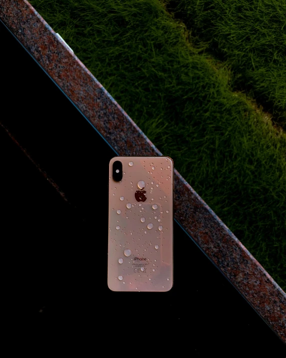 a white iphone sitting on top of a metal rail, a picture, by Robbie Trevino, unsplash contest winner, hyperrealism, covered in water drops, rose gold, profile photo, minimalist sticker