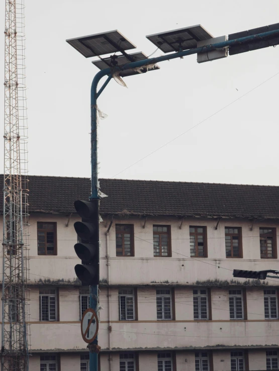 a traffic light sitting next to a tall building, by Xul Solar, deteriorated, inauguration, back view. nuri iyem, 2019 trending photo