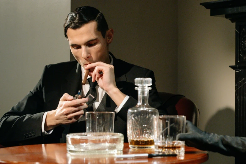 a man sitting at a table looking at his cell phone, costumes from peaky blinders, drinking whiskey, avatar image, slicked black hair