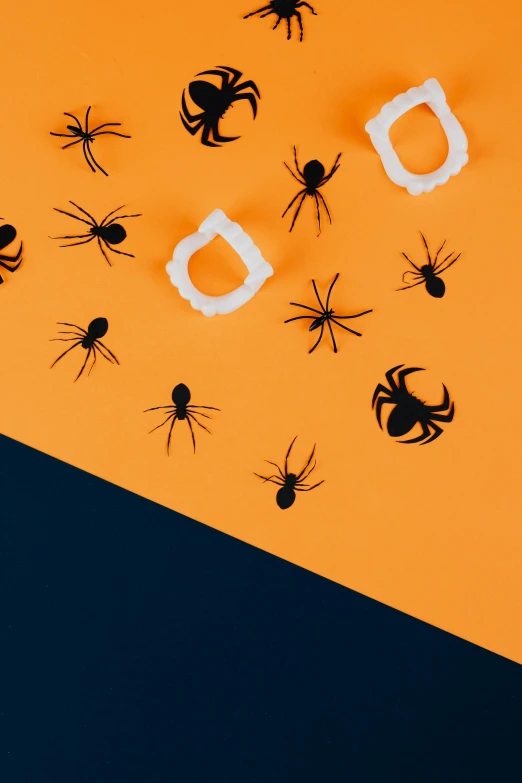 a group of black spiders on an orange and blue background, trending on unsplash, conceptual art, paper decoration, dark. no text, candy decorations, illustration:.4