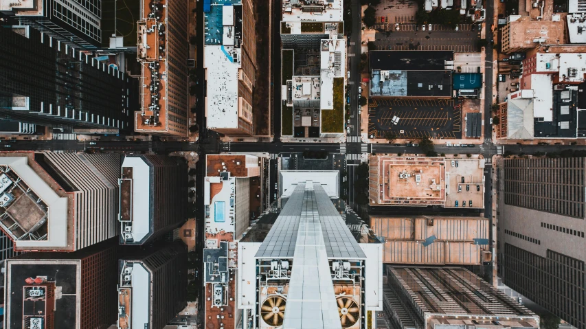 an aerial view of a city with tall buildings, by Carey Morris, unsplash contest winner, hypermodernism, camera looking down upon, upside - down building, helicopter view, thumbnail