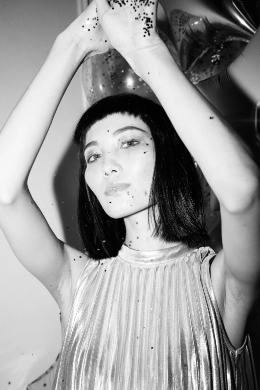 a black and white photo of a woman with sprinkles on her face, a black and white photo, inspired by Ren Hang, reddit, white french bob, shiny plastic, gemma chan, transparent body