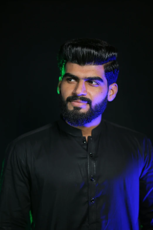 a man with a beard wearing a black shirt, featured on reddit, hurufiyya, mogul khan, transgender, headshot profile picture, arabian night