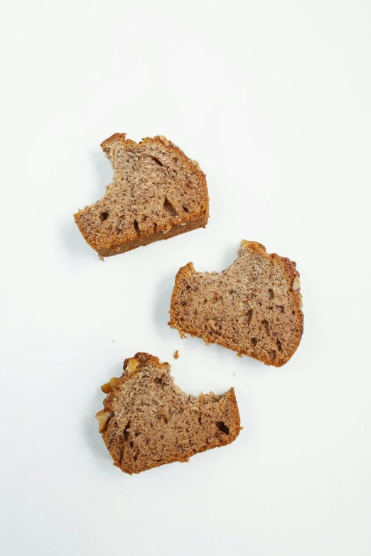 a piece of bread with a bite taken out of it, by Dietmar Damerau, unsplash, renaissance, three views, on white, walnuts, highly detailed panel cuts