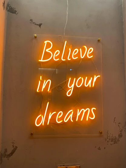 a neon sign that says believe in your dreams, by Dulah Marie Evans, pexels contest winner, orange yellow ethereal, 🚀🌈🤩, :6, indoor picture