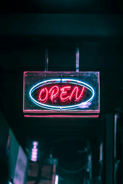 a neon sign hanging from the side of a building, pexels, happening, open room, paul barson, middle close up, open vault