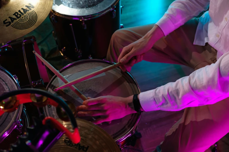 a man in a white shirt is playing drums, pexels, process art, thumbnail, birdseye view, complementary rim lights, wearing presidential band