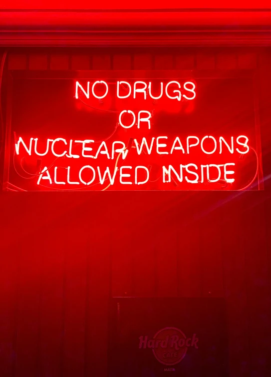 a neon sign that says no drugs or nuclear weapons allowed inside, by Kristin Nelson, pexels, 💋 💄 👠 👗, guns, cyberpunk strip clubs, andrew bernstein