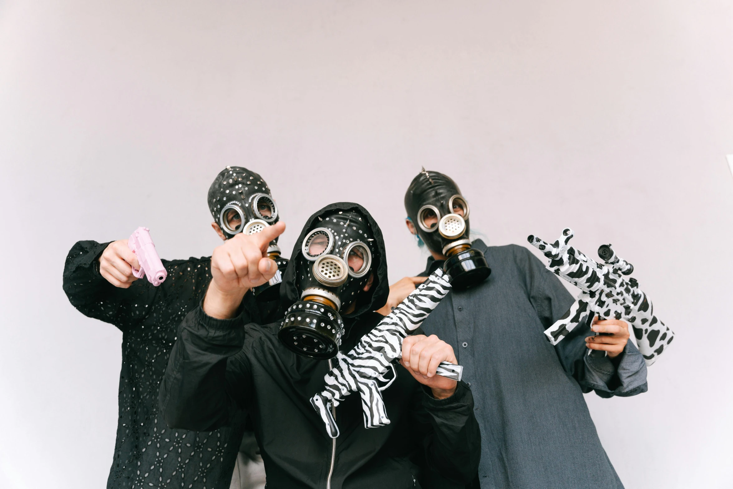 a group of people standing next to each other wearing gas masks, an album cover, by Nina Hamnett, pexels contest winner, antipodeans, toys, islamic, black lips, spots